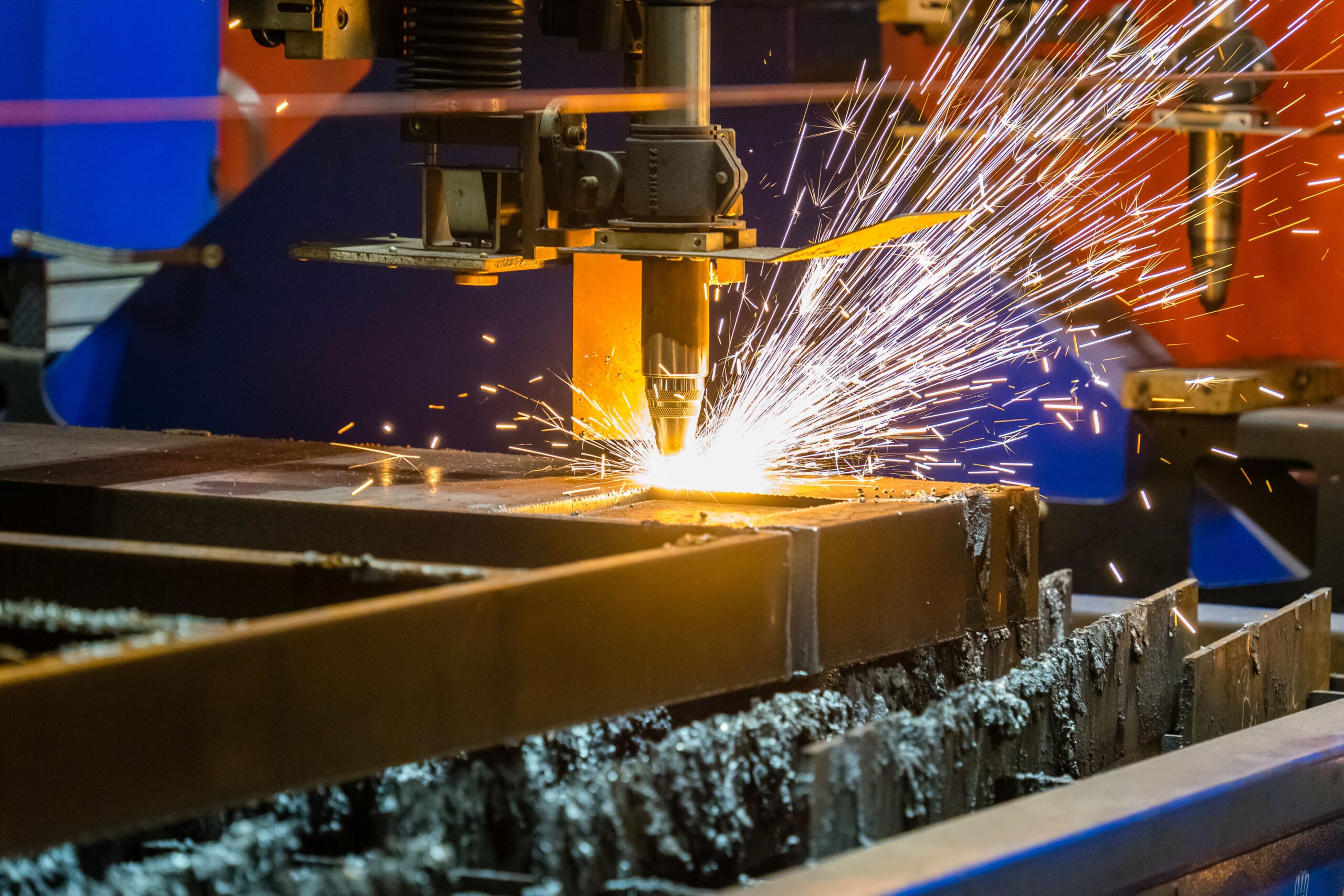 closeup-shot-sparks-flying-from-industrial-steel-cutter-min